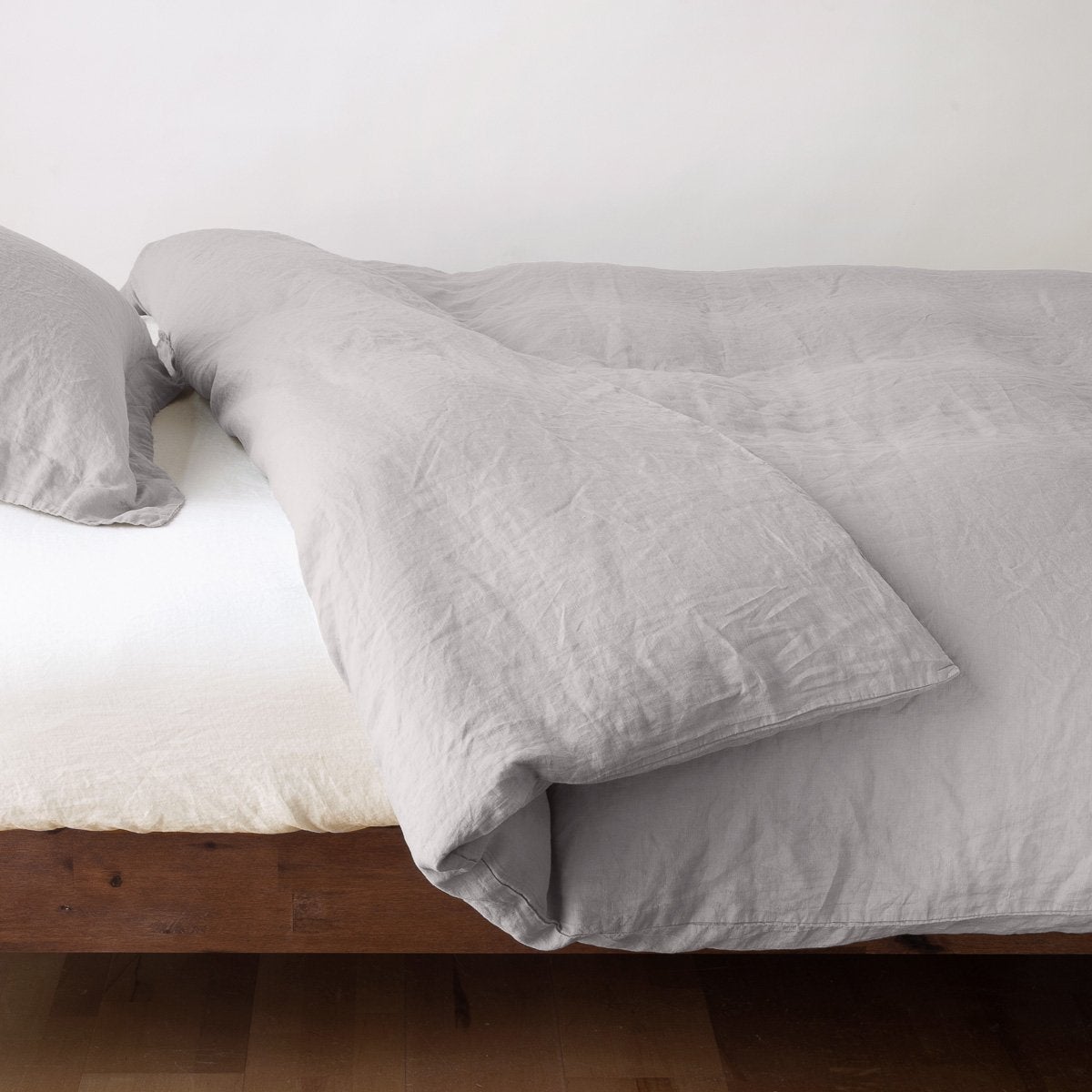 Linen Duvet Cover | Fog | duvet cover neatly folded back over white linen sheeting - side view.
