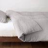 Linen Twin Duvet Cover | Fog | duvet cover neatly folded back over white linen sheeting - side view.