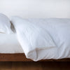 Linen Duvet Cover | White | duvet cover neatly folded back over white linen sheeting - side view.