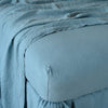 Linen Fitted Sheet | Cenote | close up of fitted sheet with matching rumpled flat sheet - corner view.