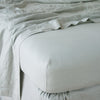 Linen Twin Fitted Sheets | Eucalyptus | close up of fitted sheet with matching rumpled flat sheet - corner view.