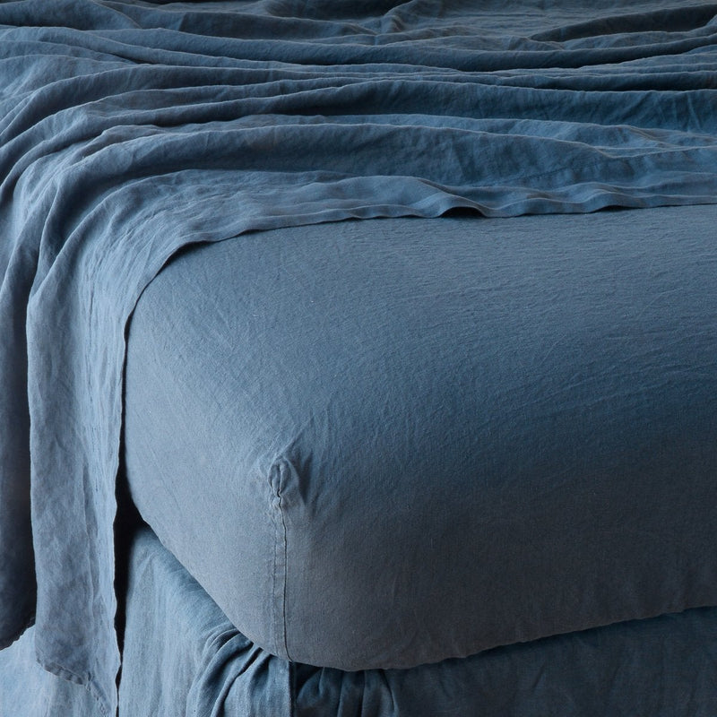 Linen Fitted Sheet | Midnight | close up of fitted sheet with matching rumpled flat sheet - corner view.