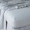 Linen Twin Fitted Sheets | Mineral | Linen fitted sheet in mineral with matching rumpled flat sheet - shown from top corner.