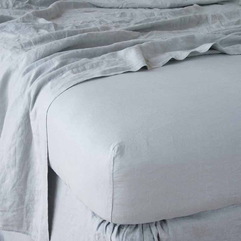 Mineral | Linen fitted sheet in mineral with matching rumpled flat sheet - shown from top corner.