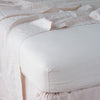 Linen Fitted Sheet | Pearl | close up of fitted sheet with matching rumpled flat sheet - corner view.