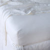 Linen Fitted Sheet | White | close up of fitted sheet with matching rumpled flat sheet - corner view.