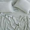 Linen Flat Sheet | Eucalyptus | Rumpled sheeting with matching sleeping pillows - overhead view.