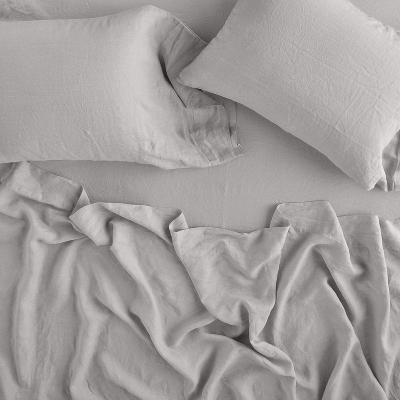 Linen Flat Sheet | Rumpled sheeting with matching sleeping pillows - overhead view.