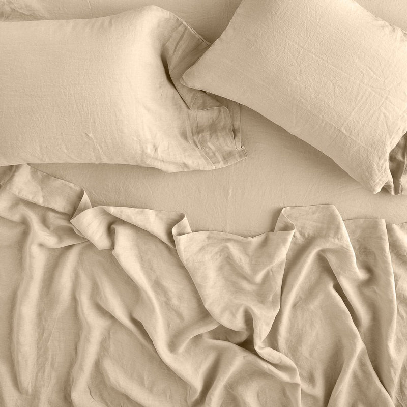 Linen Flat Sheet | Rumpled sheeting with matching sleeping pillows - overhead view.