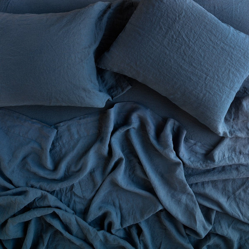 Linen Flat Sheet | Rumpled sheeting with matching sleeping pillows - overhead view.