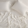 Linen Flat Sheet | Parchment | Rumpled sheeting with matching sleeping pillows - overhead view.