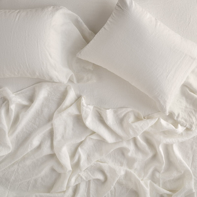 Linen Flat Sheet | Rumpled sheeting with matching sleeping pillows - overhead view.