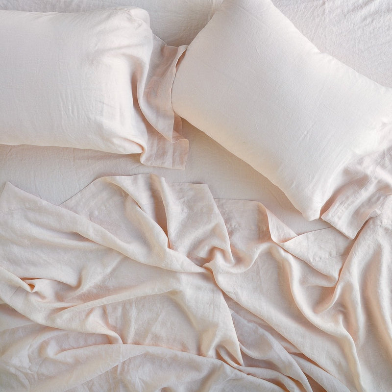 Linen Flat Sheet | Rumpled sheeting with matching sleeping pillows - overhead view.