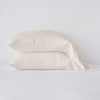 Linen Pillowcase (Single) | Parchment | Two sleeping pillows neatly stacked against a white background - side view.