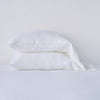 Linen Pillowcase (Single) | White | Two sleeping pillows neatly stacked against a white background - side view.