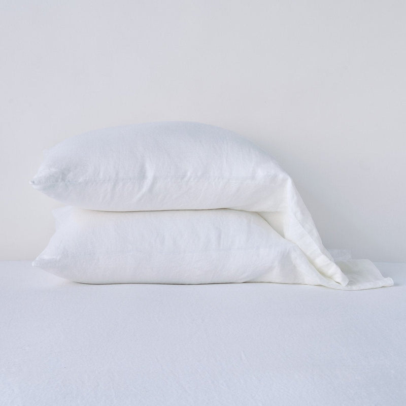 Linen Standard Pillowcase (Single) | White | Two sleeping pillows neatly stacked against a white background - side view.