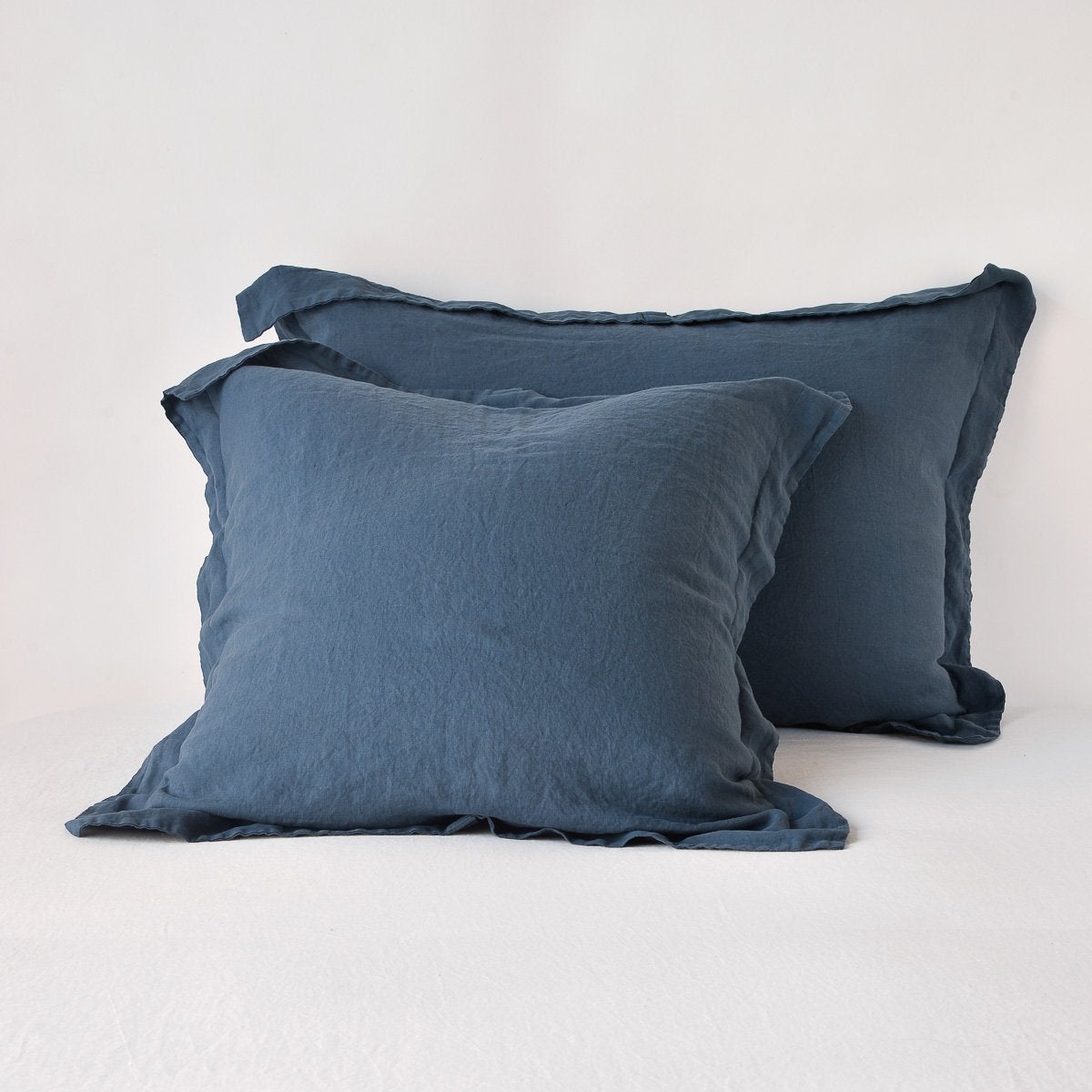 Linen Sham | Midnight | Two shams leaning upright against a white background.
