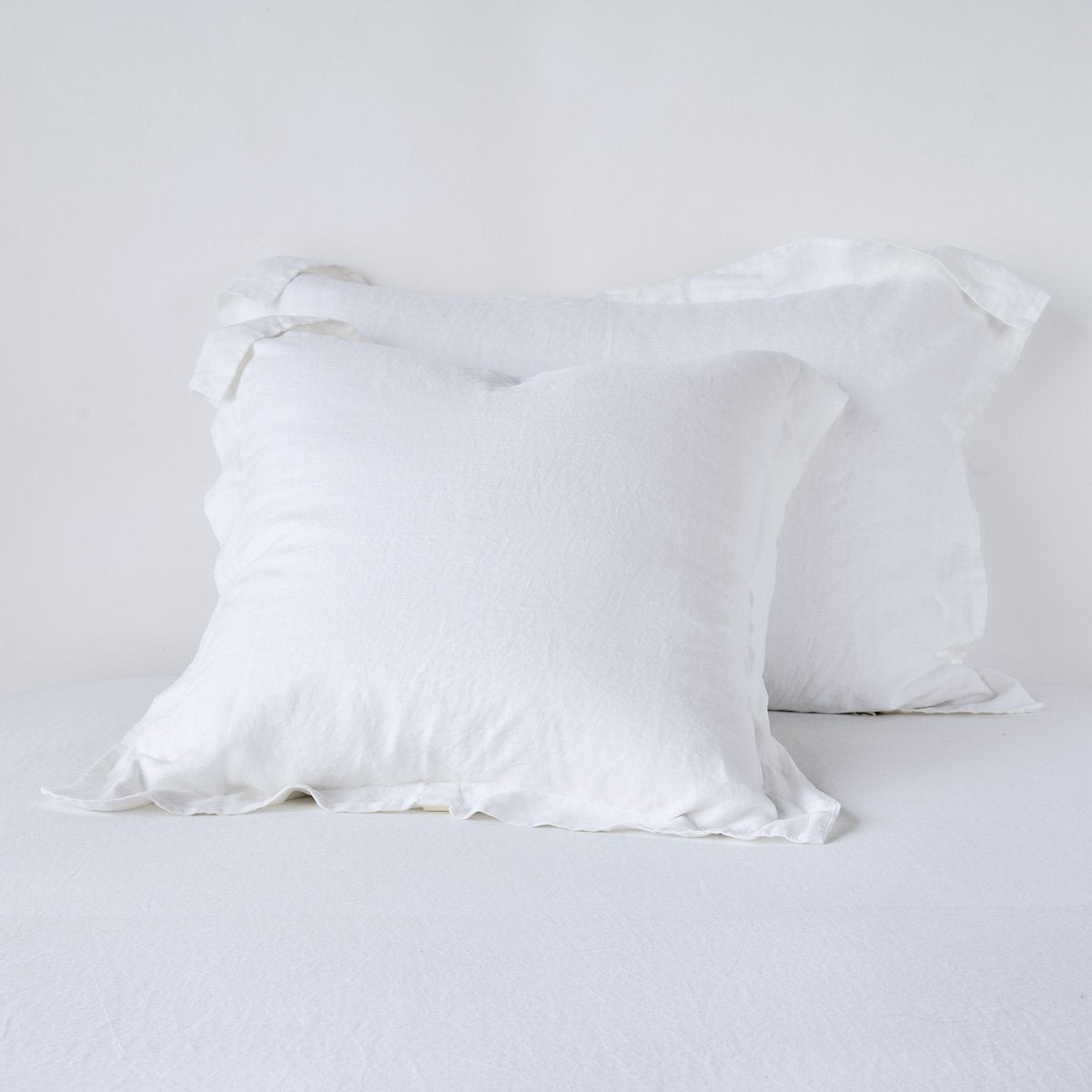 Linen Sham | White | Two shams leaning upright against a white background.