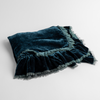 Loulah Baby Blanket | Cenote | an overhead shot of a folded silk velvet baby blanket with a raw-edged eyelash ruffle detail.