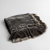 Loulah Baby Blanket | Fog | an overhead shot of a folded silk velvet baby blanket with a raw-edged eyelash ruffle detail.