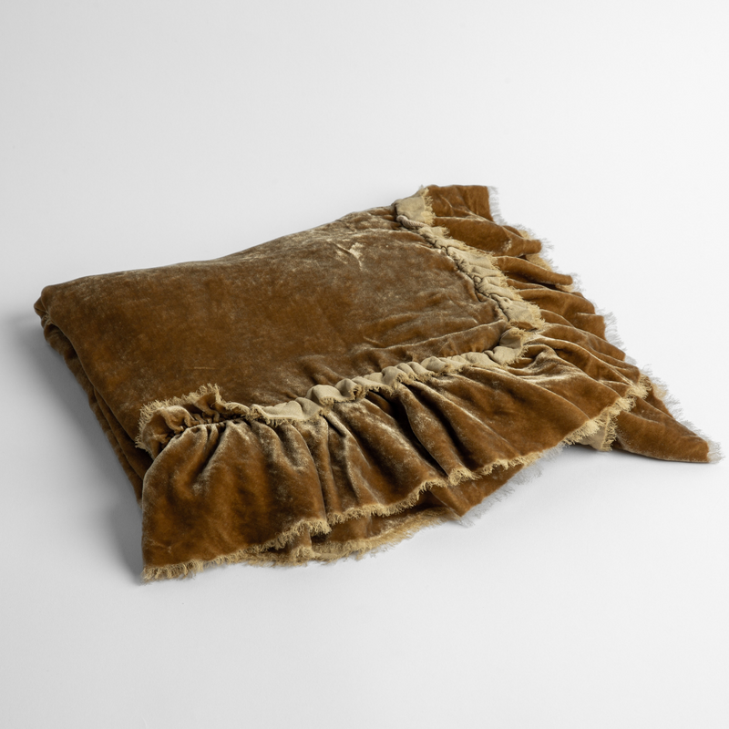 Loulah Baby Blanket | Honeycomb | an overhead shot of a folded silk velvet baby blanket with a raw-edged eyelash ruffle detail.