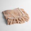 Loulah Baby Blanket | Pearl | an overhead shot of a folded silk velvet baby blanket with a raw-edged eyelash ruffle detail.