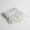 Loulah Baby Blanket | White | an overhead shot of a folded silk velvet baby blanket with a raw-edged eyelash ruffle detail.