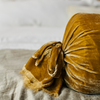 Loulah Throw Pillow | a close up of the end of a bolster pillow showing the raw edge ruffle on the tied end.