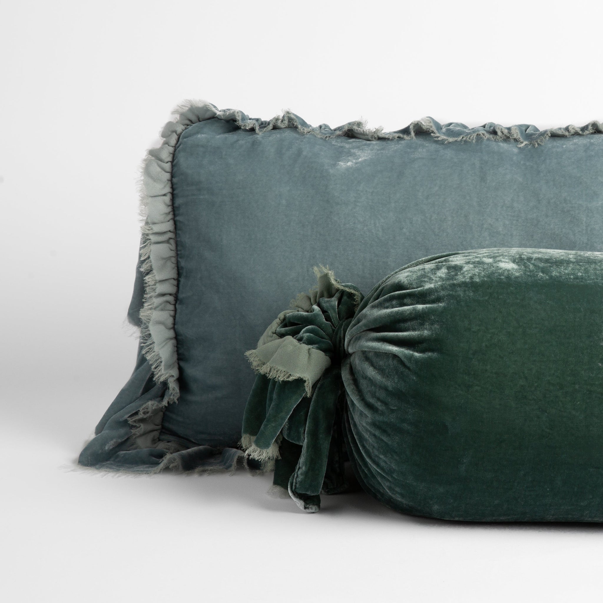 Loulah Throw Pillow | silk velvet throw pillows with raw edge ruffle details; cool tones straight on against a white background.