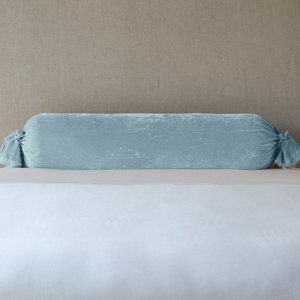 Loulah Throw Pillow | Cloud | bolster shown against neutral background and white foreground