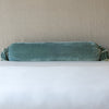 Loulah Throw Pillow | Eucalyptus | bolster shown against neutral background and white foreground