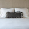Loulah Throw Pillow | Fog | pillow on a white bed - cropped end of bed view.