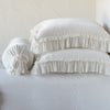 Loulah Sham | Winter White | Two shams stacked flat next to matching bolster. Close-up side view highlights the ruffle trim.
