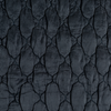 Luna Twin Coverlet | Midnight | A close up of quilted charmeuse fabric in midnight, a rich indigo tone.