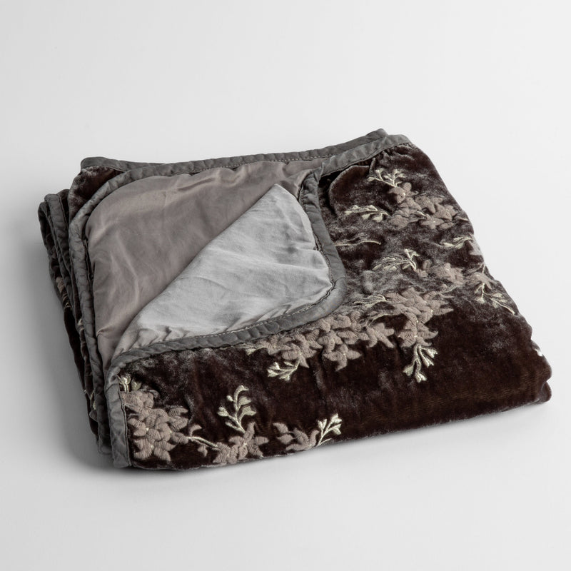 Lynette Baby Blanket | Moonlight | embroidered silk velvet baby blanket folded with a corner folded back to show the trim and back of the blanket - shot overhead at a slight angle against a white background.