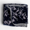 Lynette Blanket | French Lavender | embroidered silk velvet blanket folded with its corners pulled down to show trim contrast - overhead against a white background.