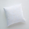 Lynette Throw Pillow | White | pillow against a plain background - overhead view.