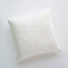 Lynette Throw Pillow | Winter White | pillow against a plain background - overhead view.