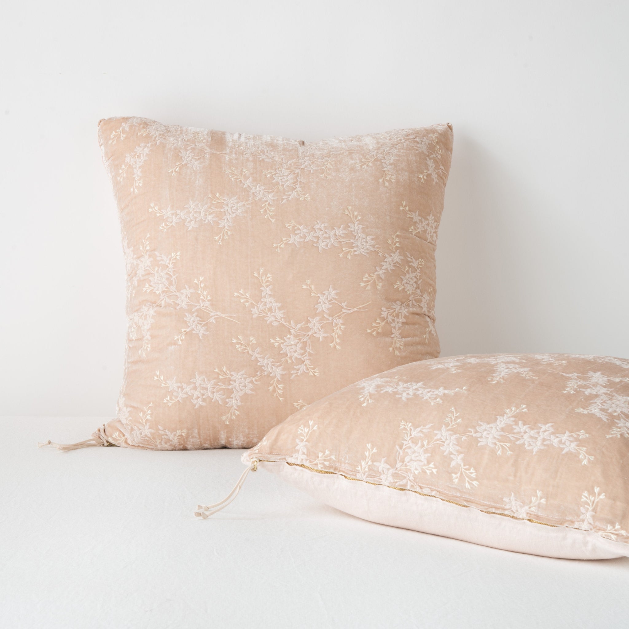 Two Lynette shams against a light background | one upright and one laying flat, highlighting zipper detail and linen back.