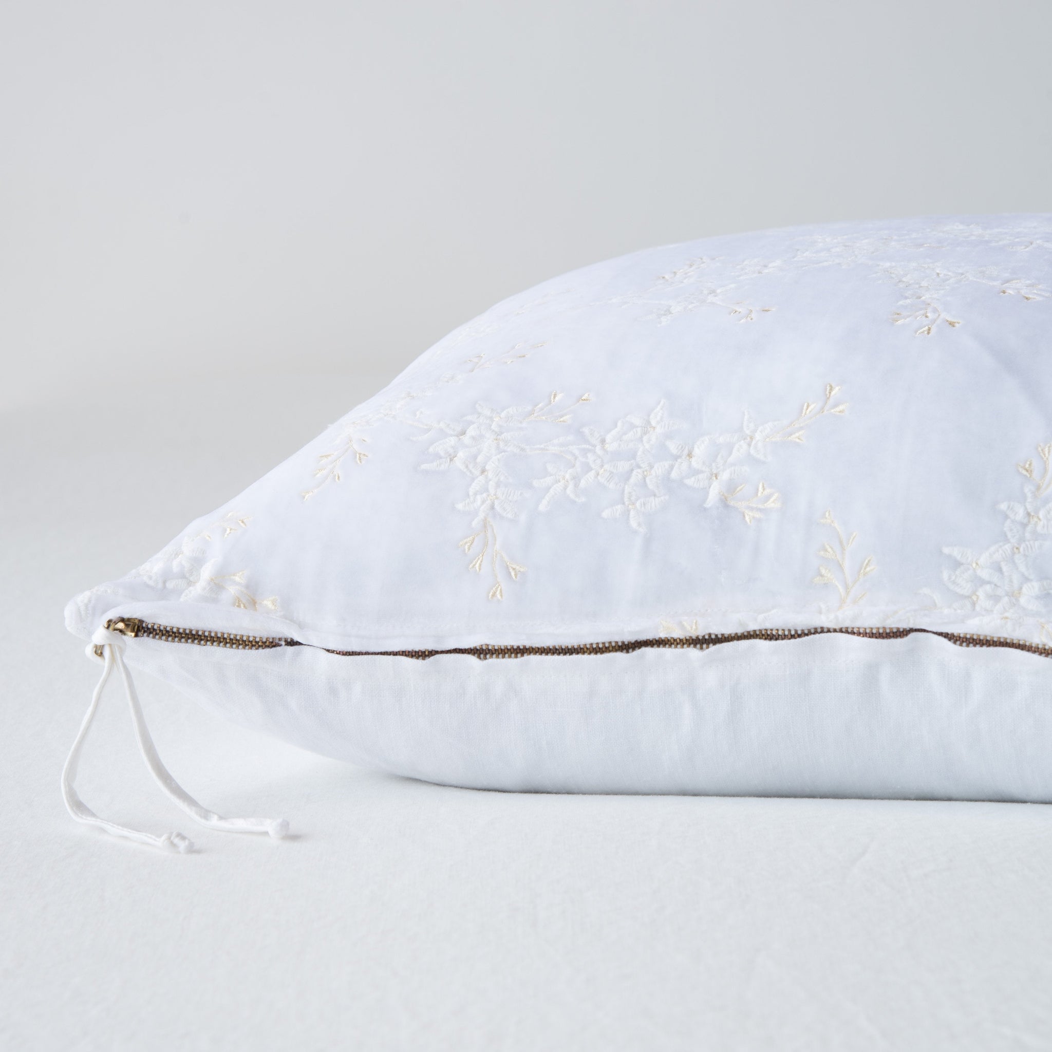 Lynette Sham | White | Close-up side vew featuring brass zipper with charmeuse pull, and linen back.