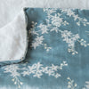 Lynette Blanket | Cloud | Close up of blanket, with a corner turned back to showcase the linen back - overhead view.