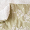 Lynette Blanket | Parchment | Close up of blanket, with a corner turned back to showcase the linen back - overhead view.