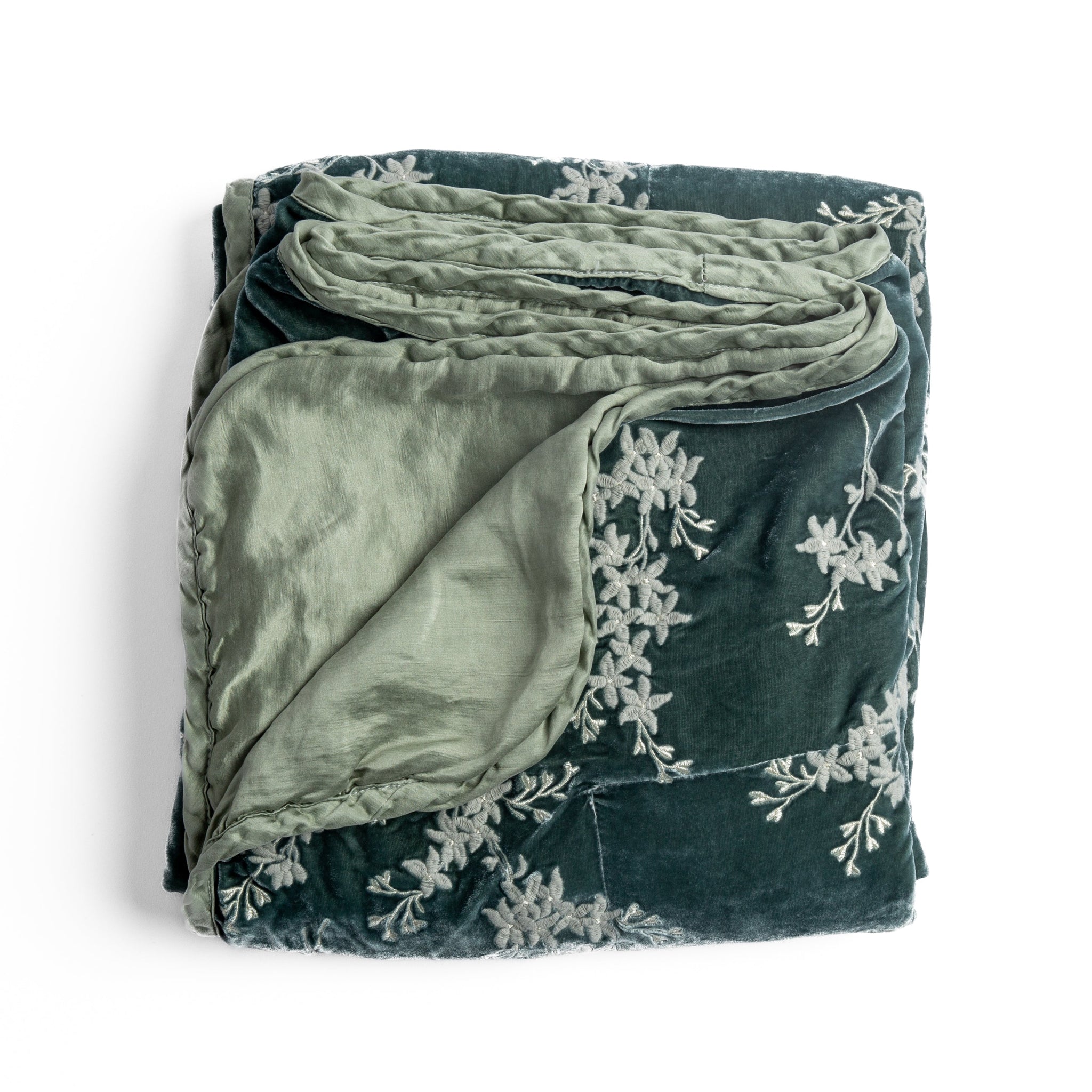 Lynette Blanket | Eucalyptus | overhead angle of the folded blanket with a corner pulled back to show the reverse and trim.