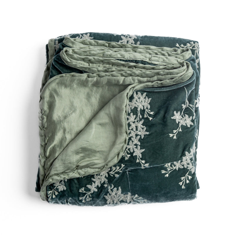 Lynette Blanket | Eucalyptus | overhead angle of the folded blanket with a corner pulled back to show the reverse and trim.