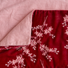 Lynette Blanket | Poppy | Close up of blanket, with a corner turned back to showcase the linen back - overhead view.