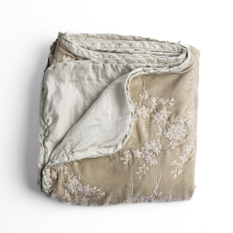 Lynette Blanket | Parchment | overhead angle of the folded blanket with a corner pulled back to show the reverse and trim.