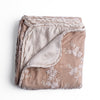 Lynette Blanket | Pearl | overhead angle of the folded blanket with a corner pulled back to show the reverse and trim.