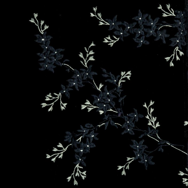 Lynette Sham | Corvino | A close up of embroidered silk velvet fabric in Corvino, a black tone.