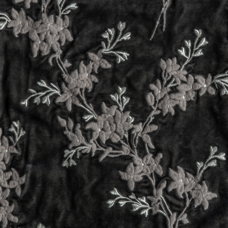 Lynette Blanket | Fog | A close up of embroidered silk velvet fabric in fog, a neutral-warm, soft mid-tone grey.