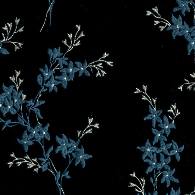 Lynette Blanket | Midnight | A close up of embroidered silk velvet fabric in midnight, a rich indigo tone.